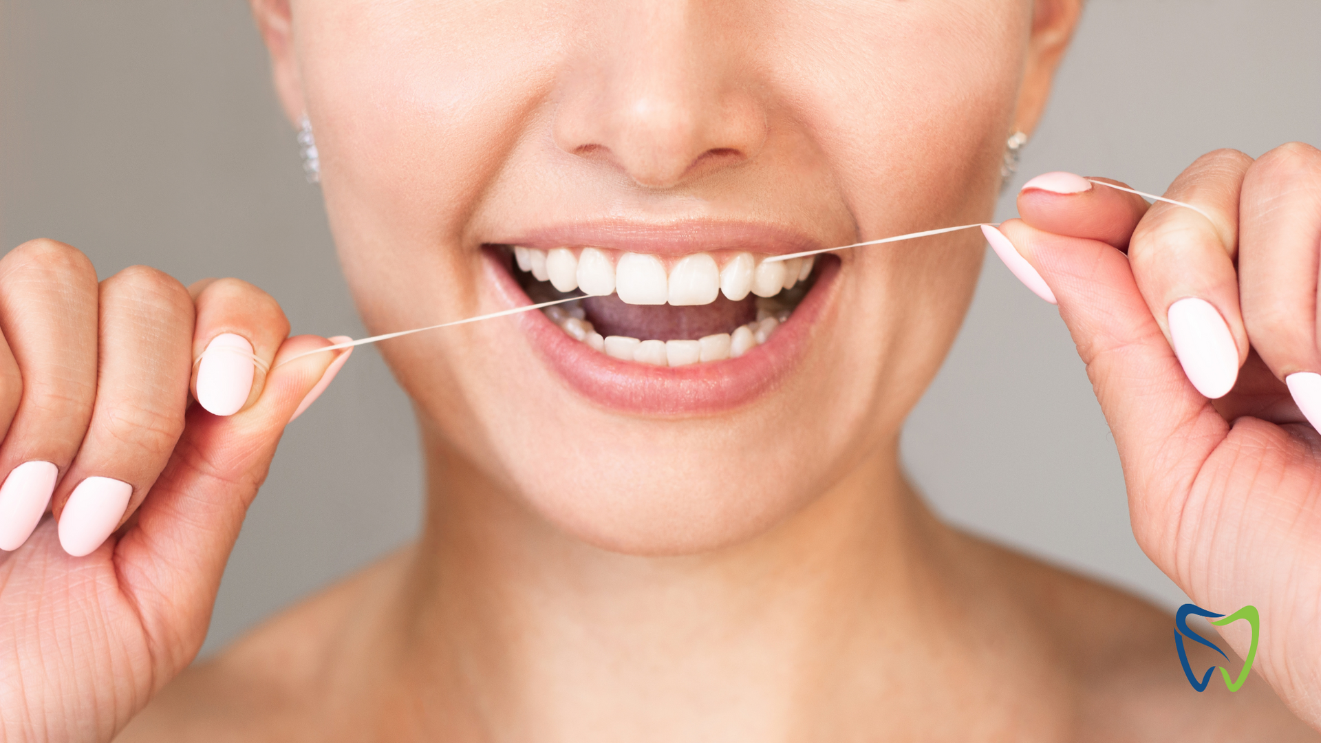 A woman is flossing her teeth with a dental floss.