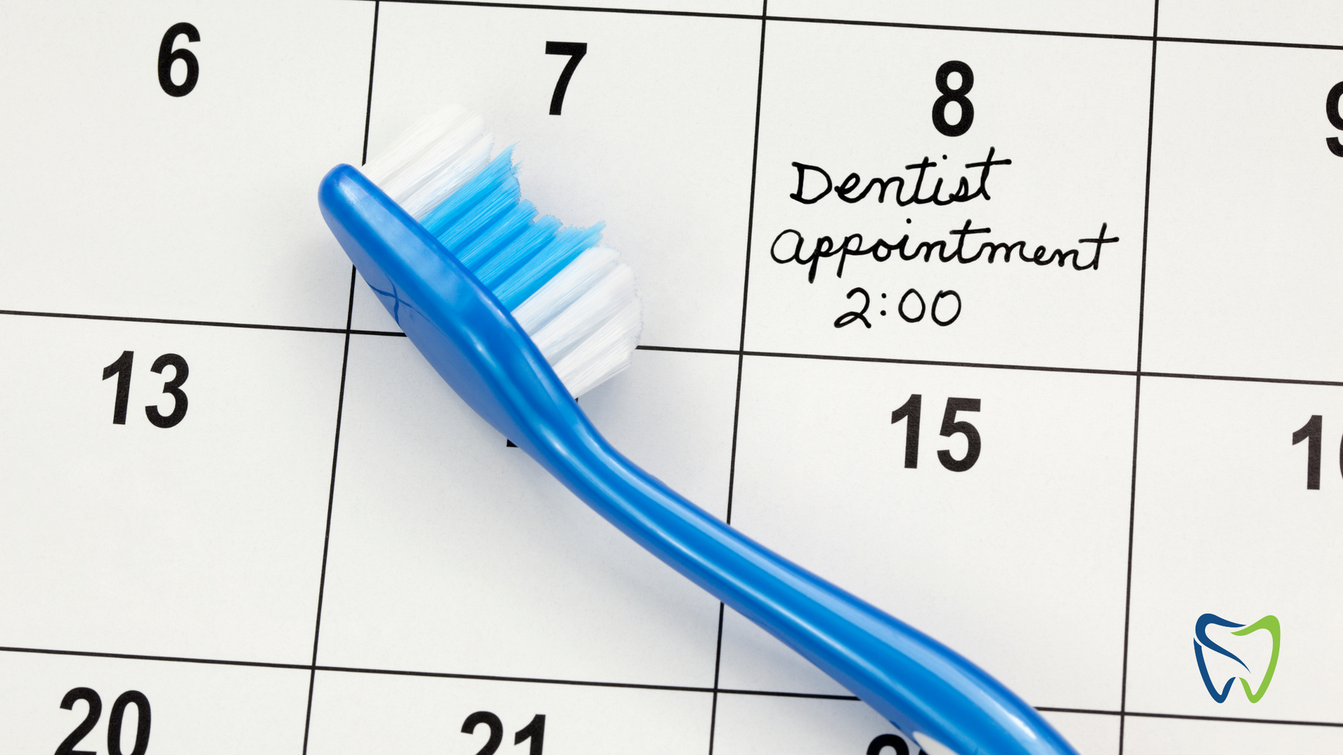 A blue toothbrush sitting on top of a calendar that says dentist appointment 2:00