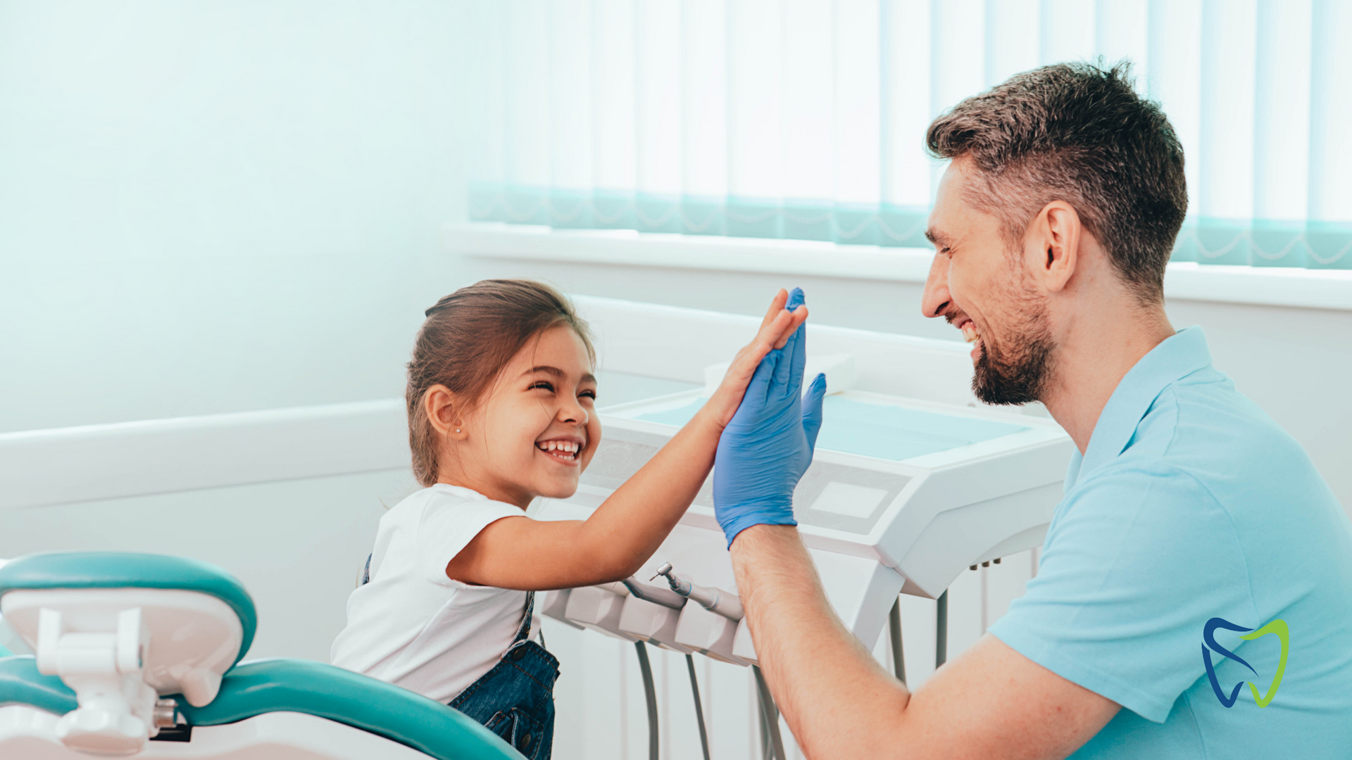 A dentist and a little girl are giving each other a high five in a dental office.