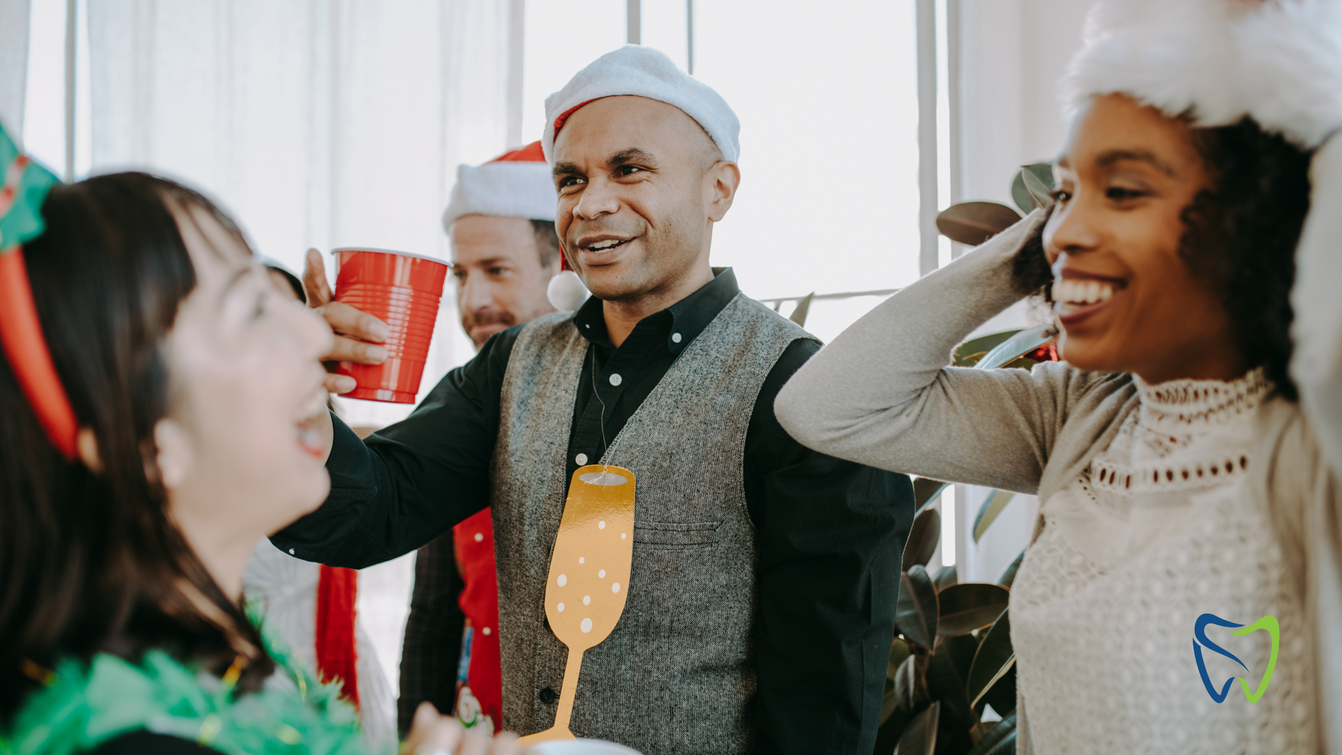 A group of people are standing around a table at a christmas party.