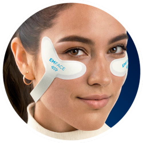 Woman wearing EMFACE eye patches. White patches on face.