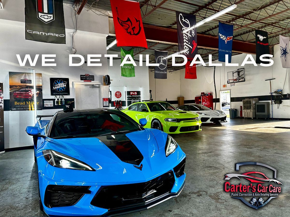A car detailing shop in Dallas with three sports cars, the front one being blue.