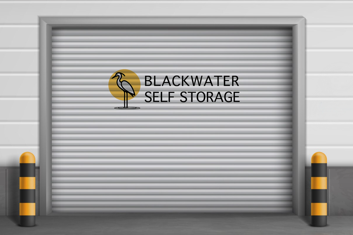 A blackwater self storage garage door with a bird on it.