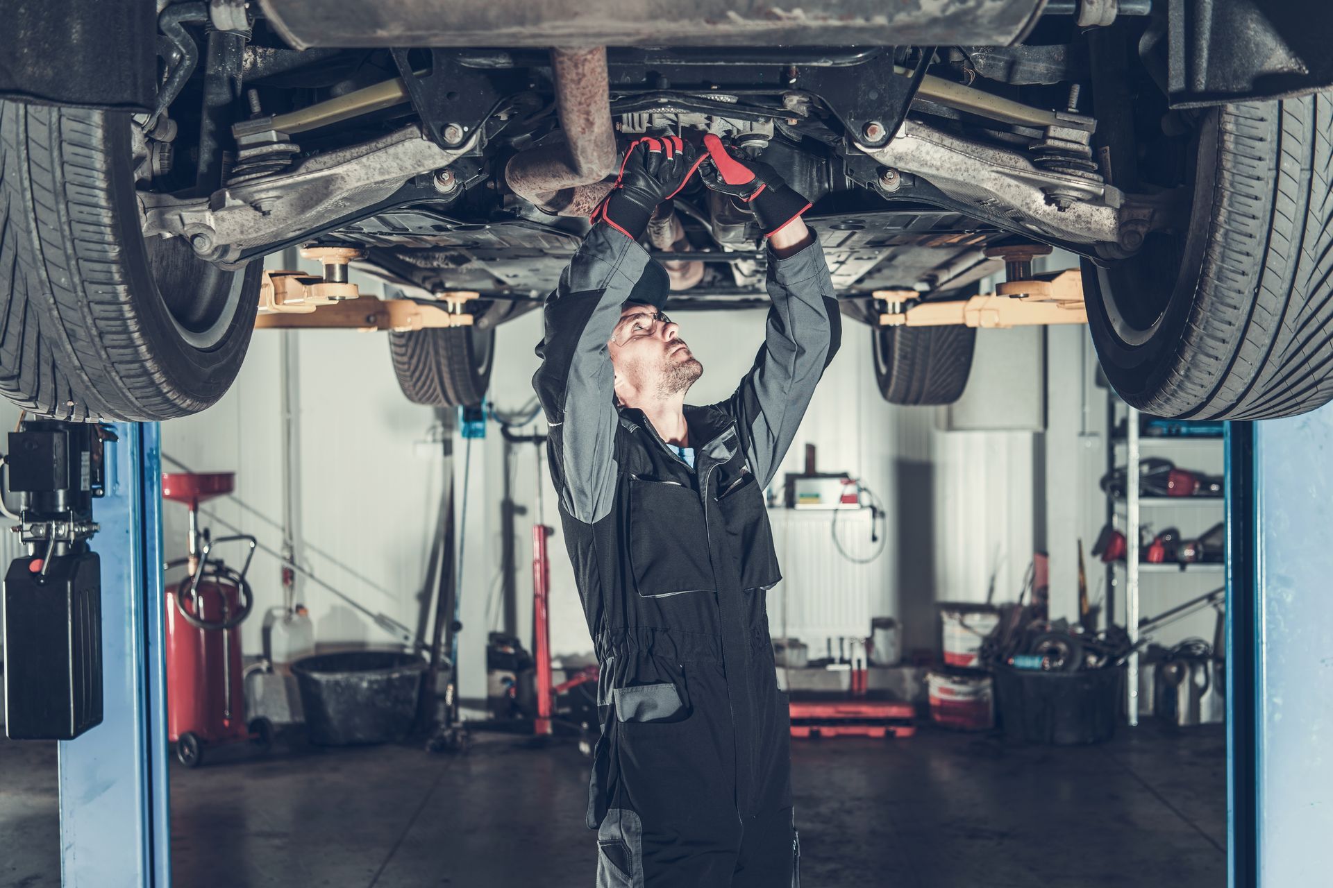 Mechanic working on a car on a lift