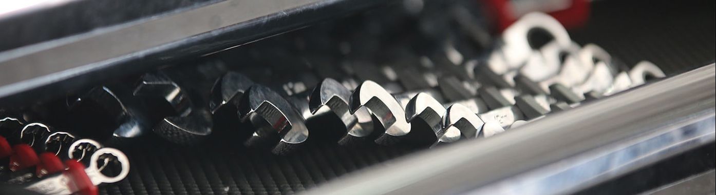 A drawer with various wrenches and tools, mostly metal and silver, organized in a tool chest | Good Honest Mechanic