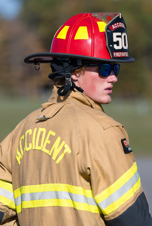 Firefighter in red helmet and tan uniform, 