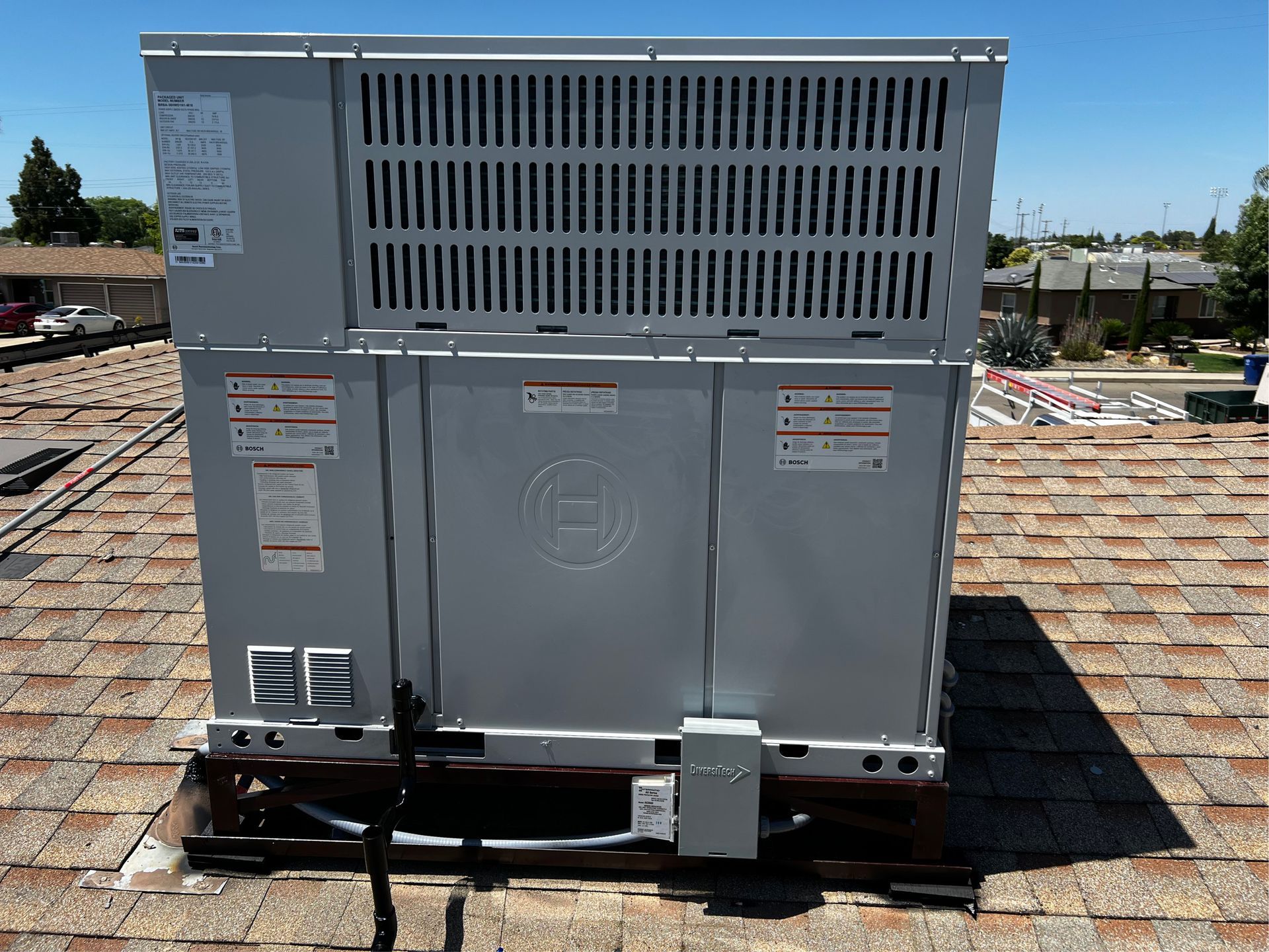 An air conditioner is sitting on top of a roof