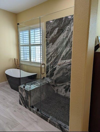 A bathroom with a bathtub and a walk in shower.