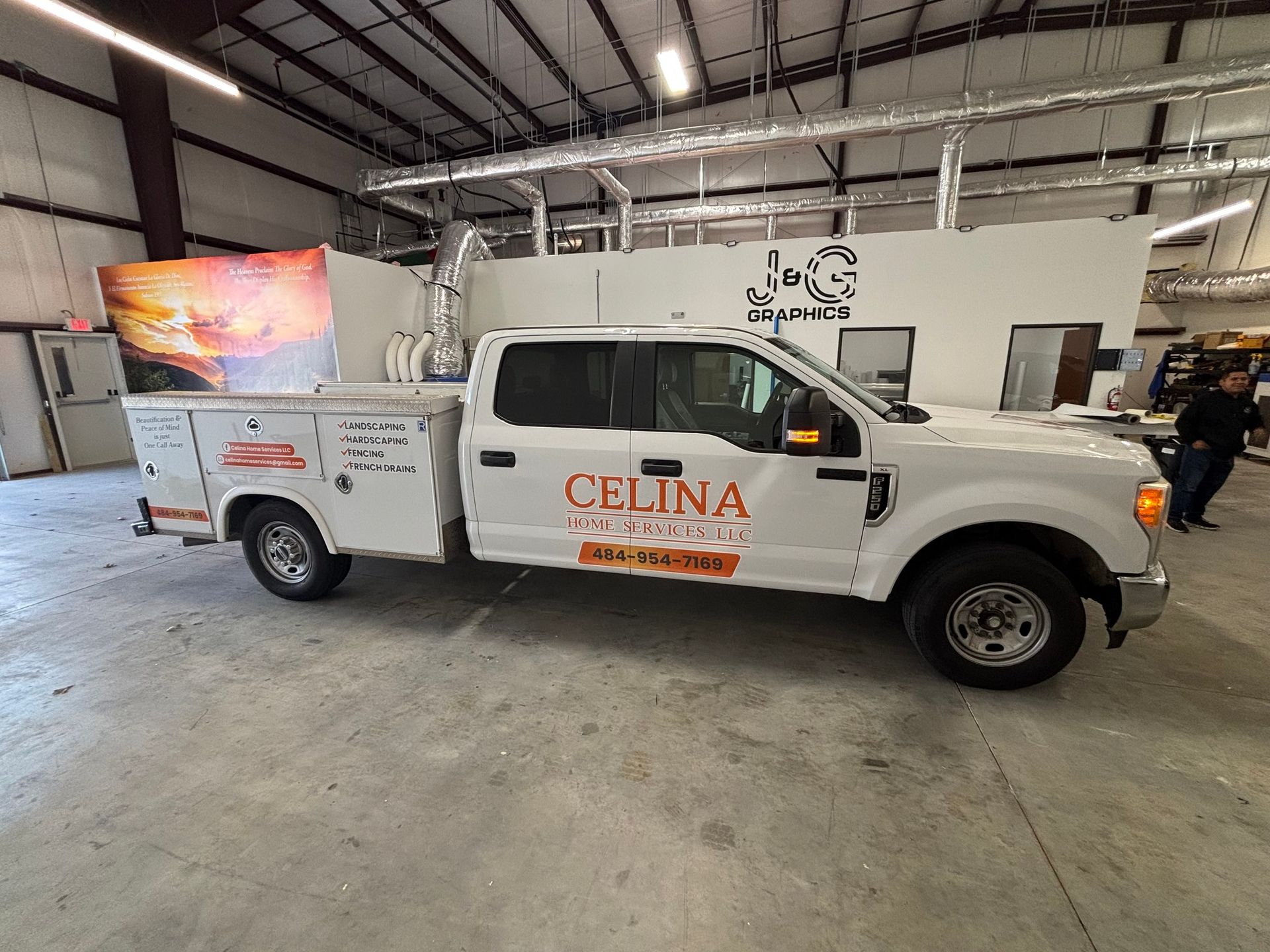 White Celina utility truck parked inside a warehouse.