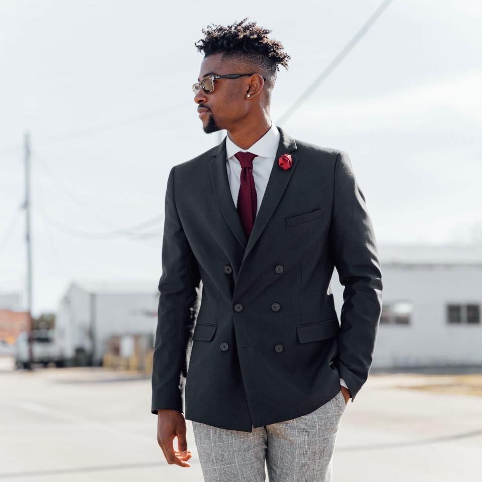 a man in a suit and tie is walking down the street