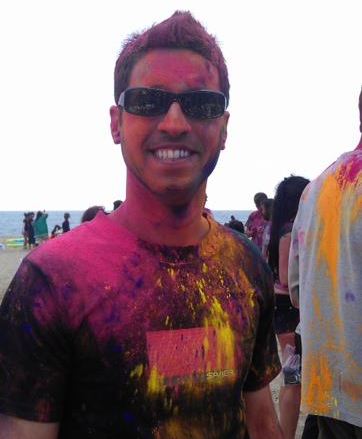 a man is covered in colored powder and wearing sunglasses