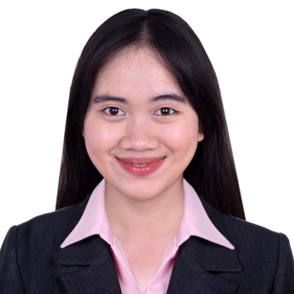 Woman with long black hair, smiling, wearing a pink shirt and black blazer.