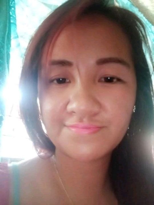 A close up of a woman 's face with a smile on her face.