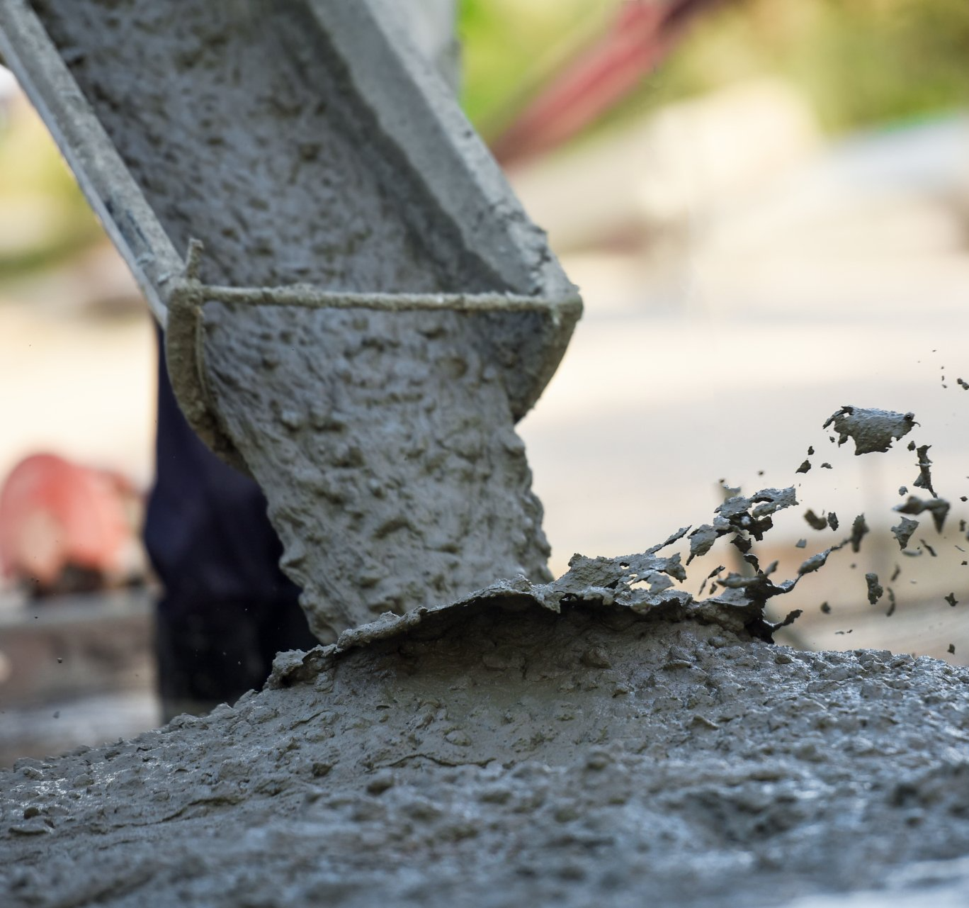 A person is pouring concrete into a pile