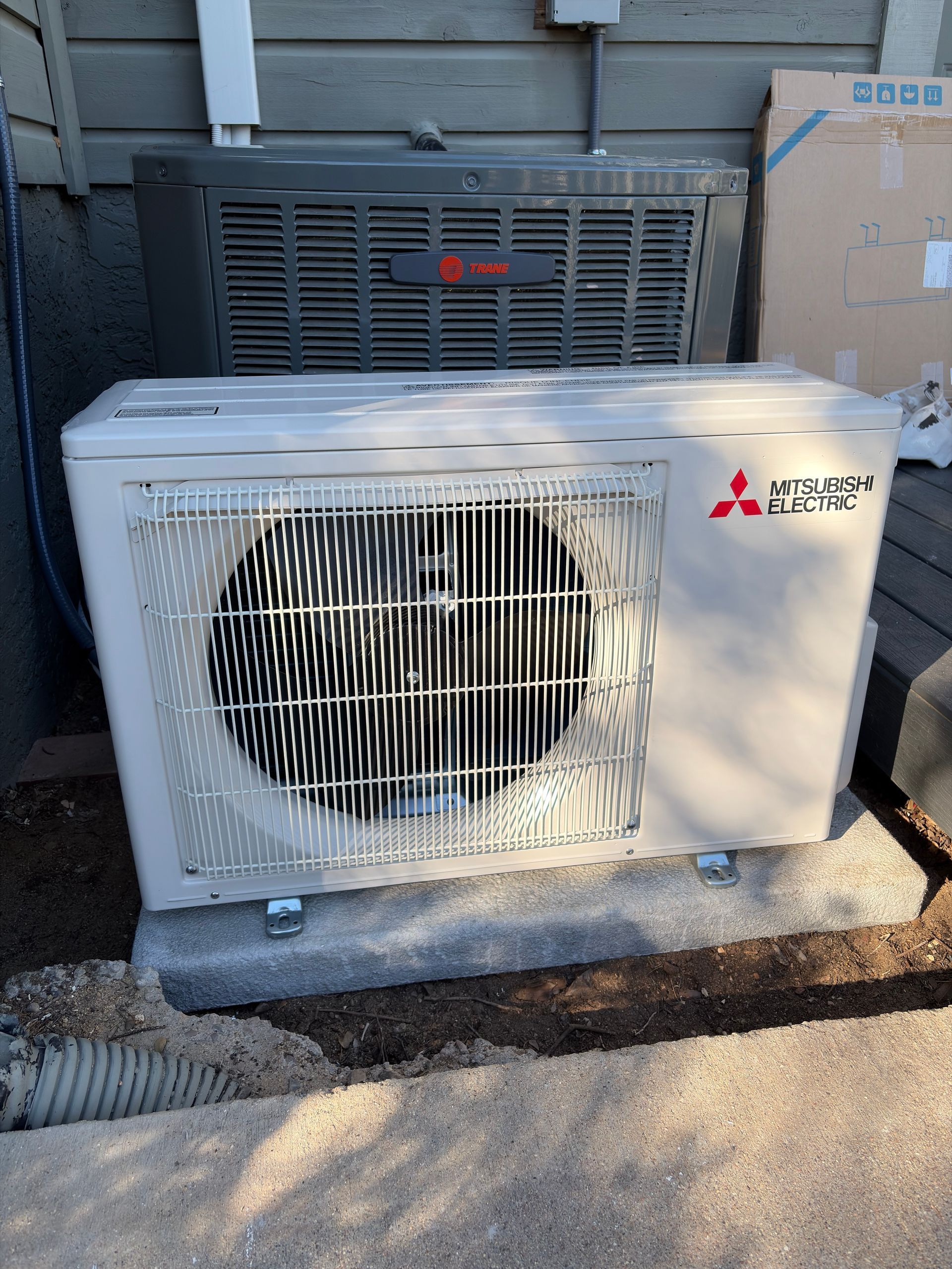 A mini split system on the side of a house