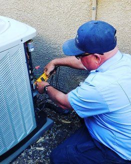 A person repairing a HVAC system