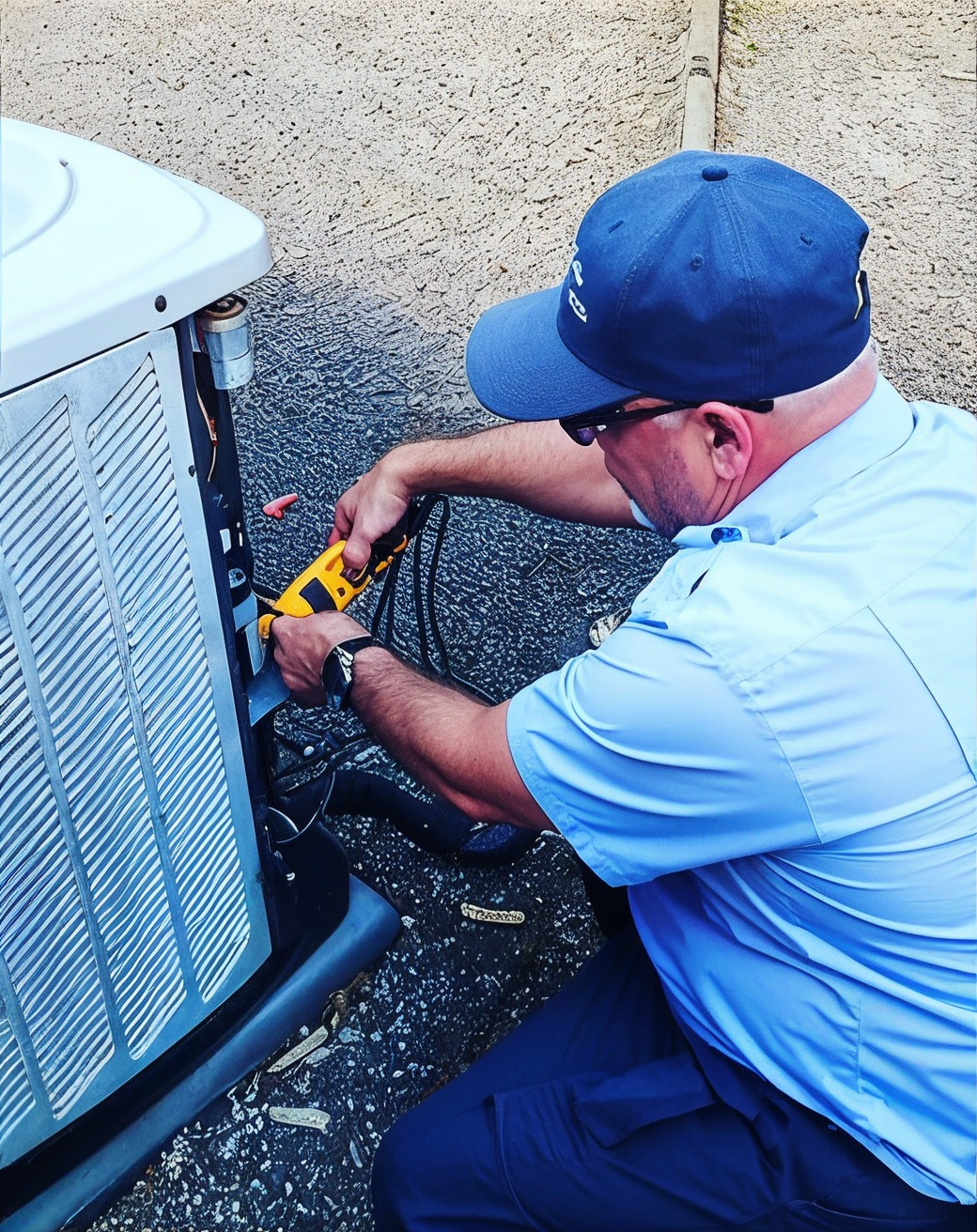 Man in mask working on an AC unit on a rooftop.