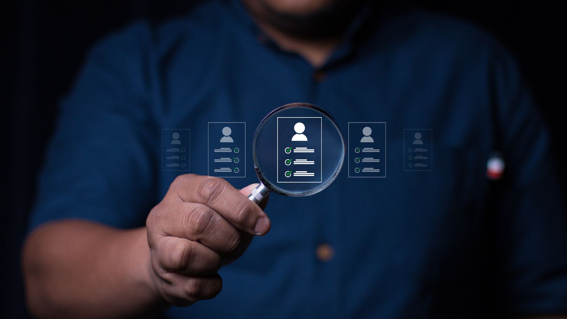 A man is holding a magnifying glass in his hand.