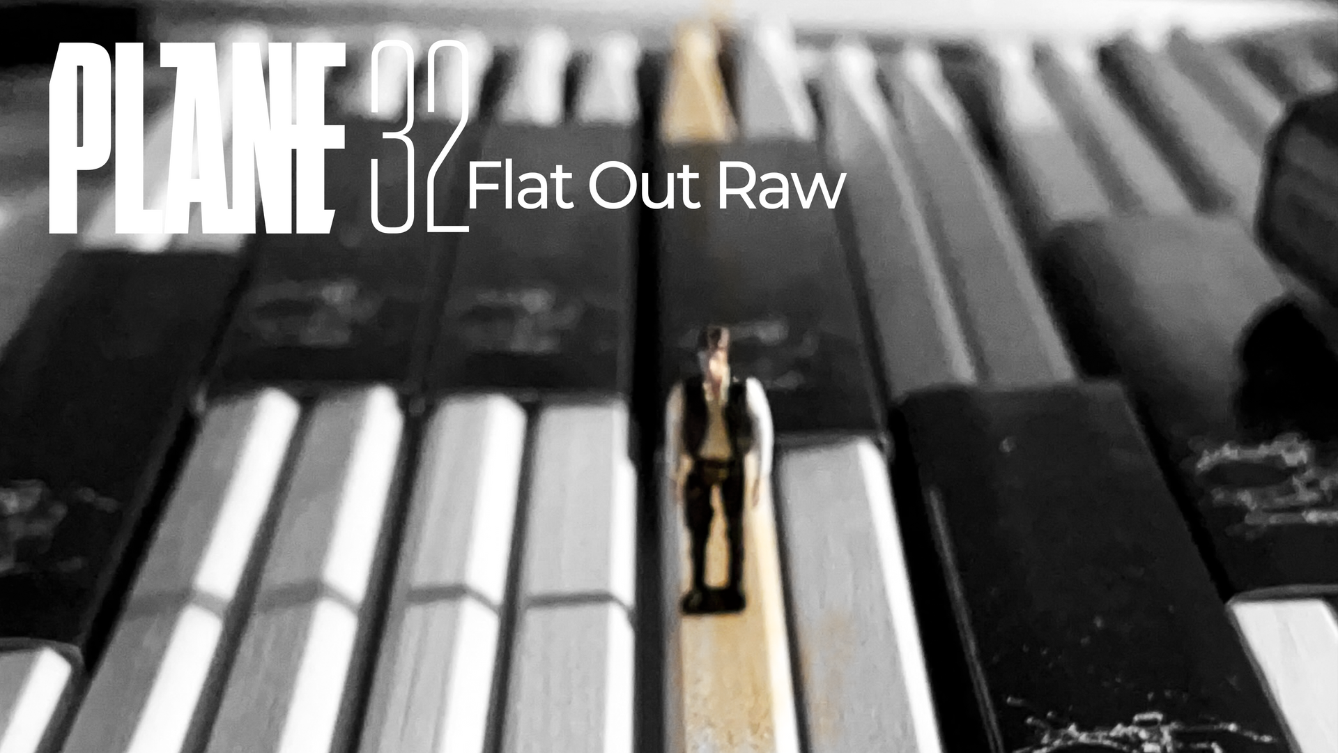 Miniature figure on a piano key; the title