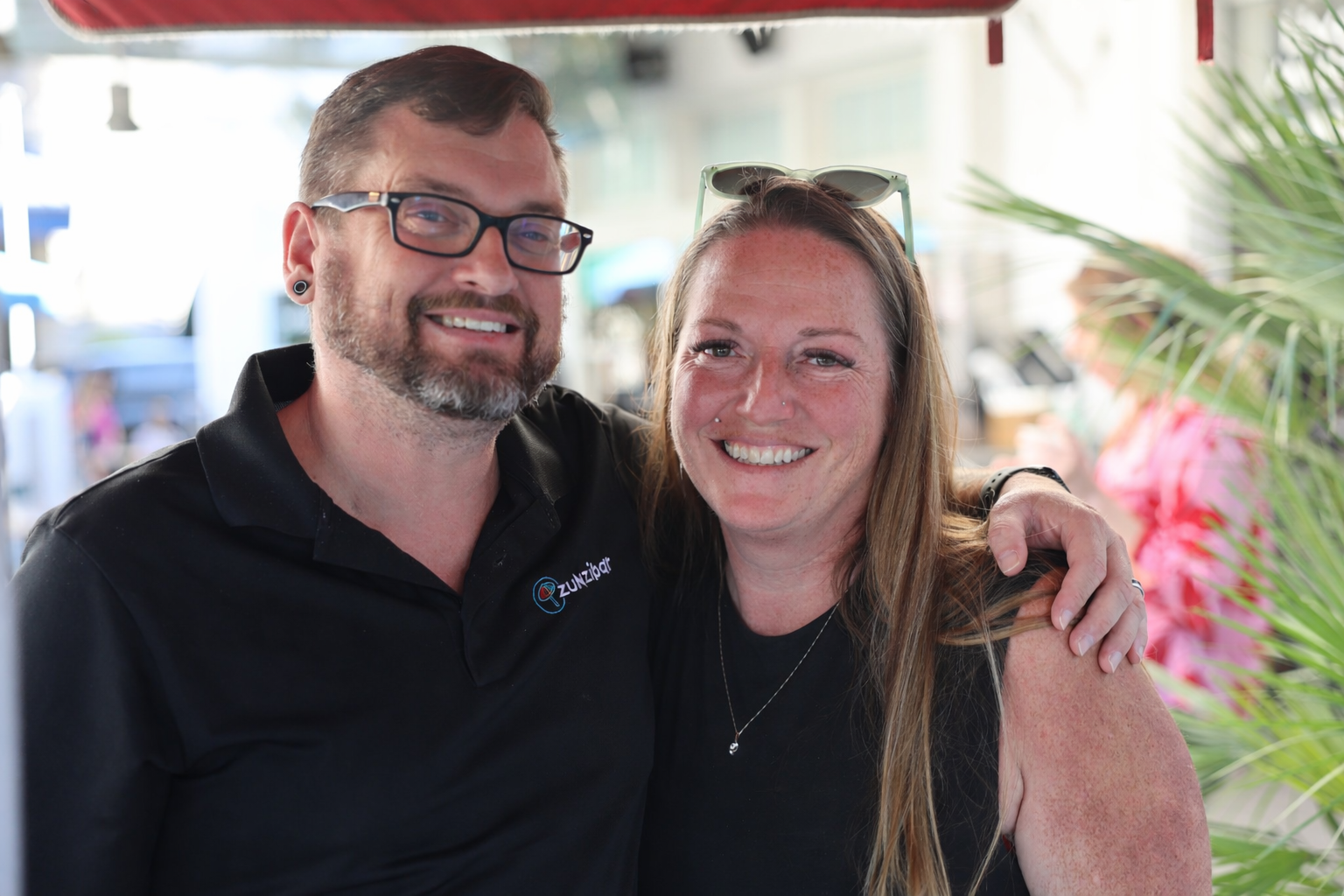A woman is shaking a drink in a bar.