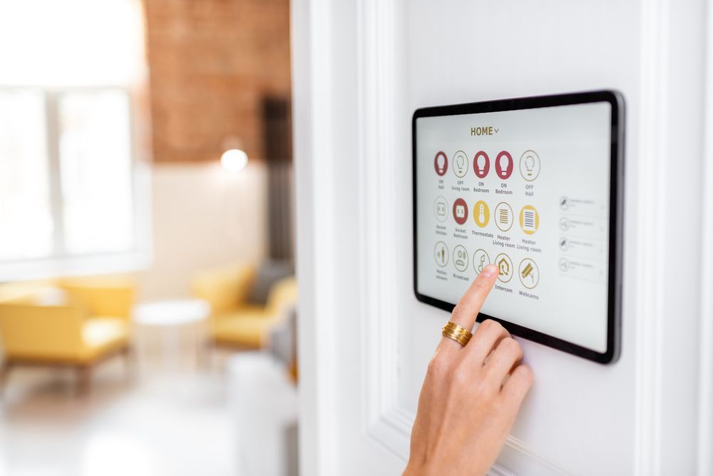 A person is pressing a button on a tablet in a living room.