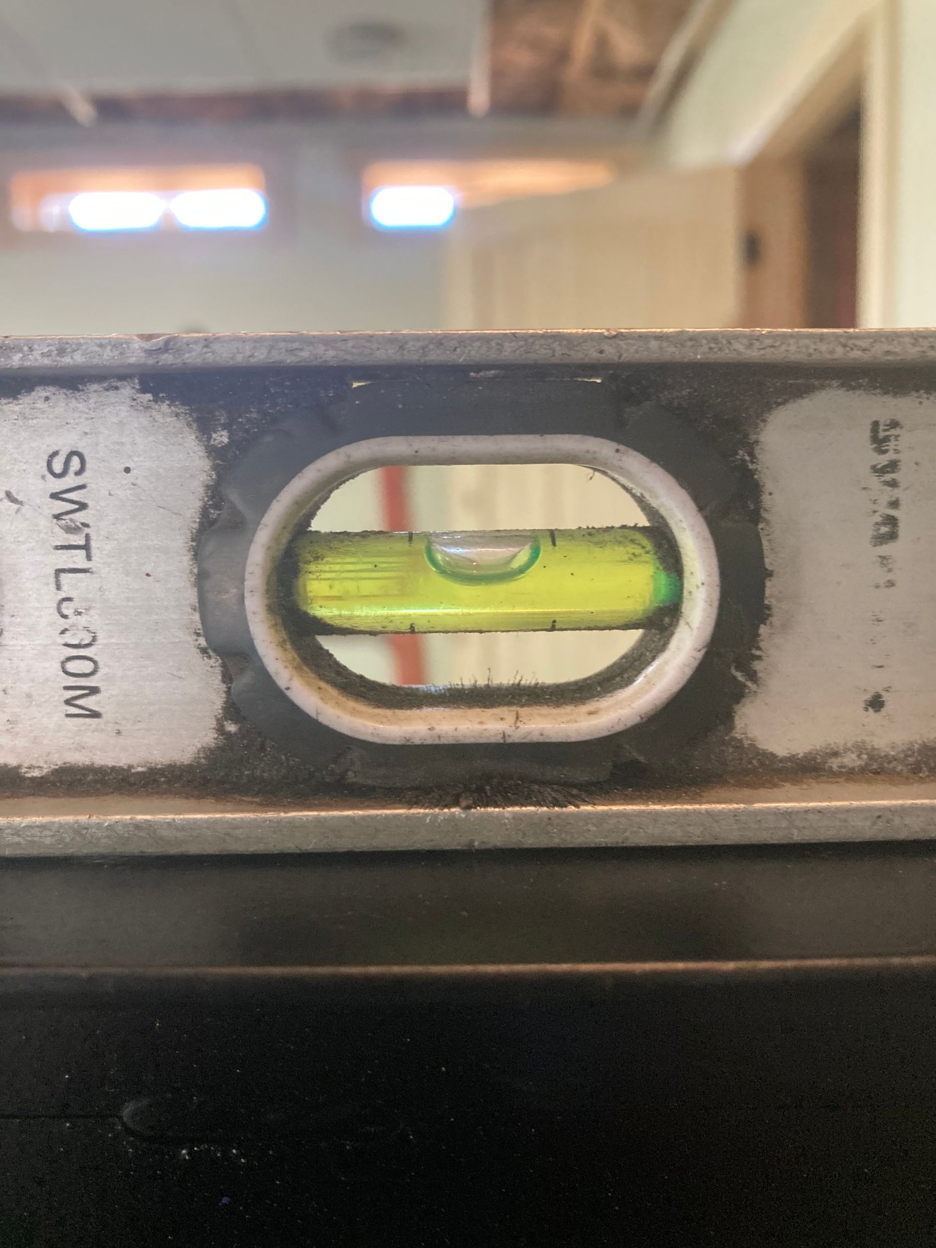 A close up of a level with a yellow liquid in it.