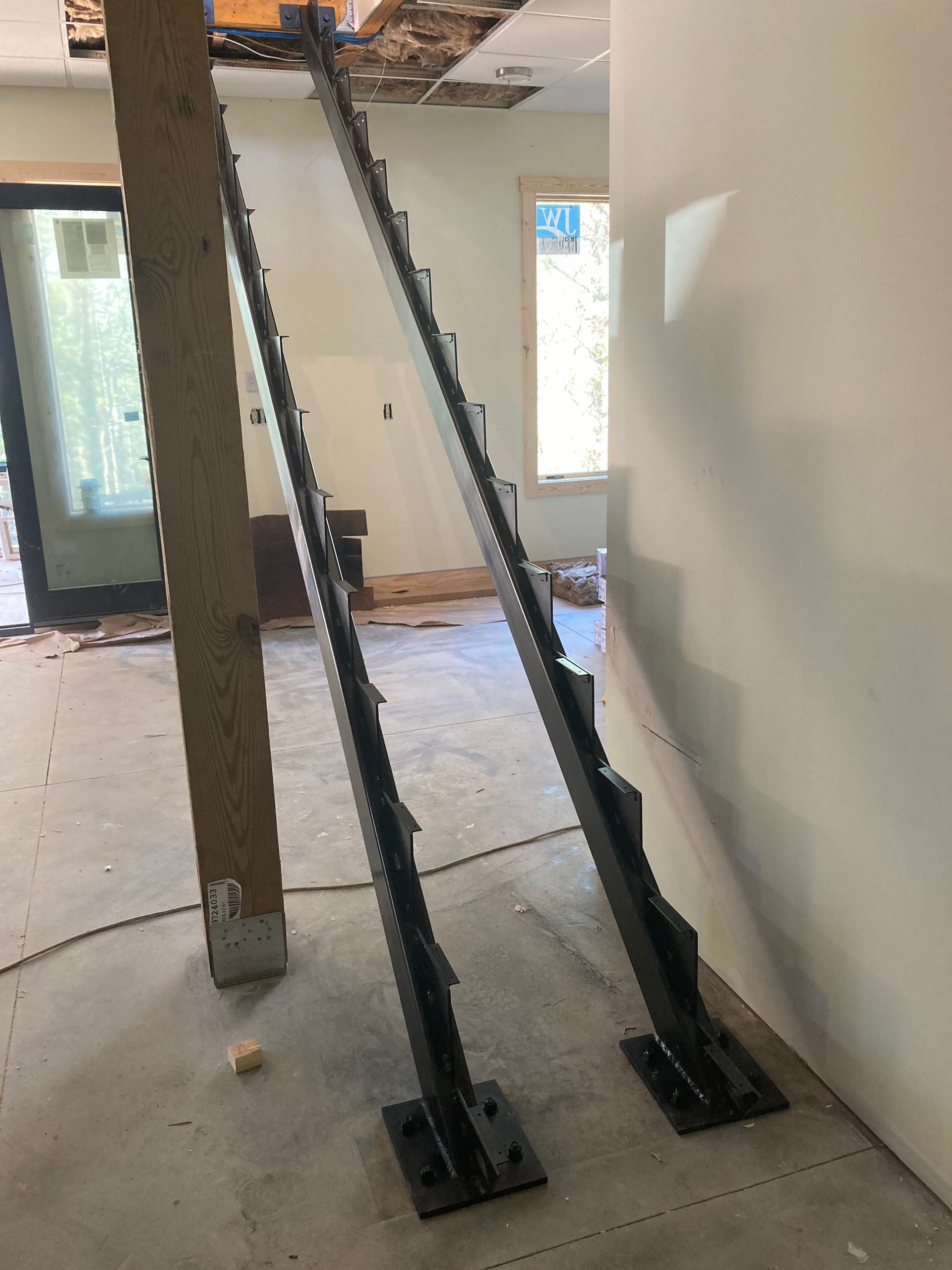 A metal staircase is being built in a room.