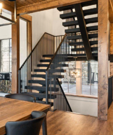 A dining room with a table and chairs and a staircase