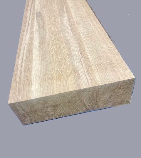 A piece of wood is sitting on a gray surface.