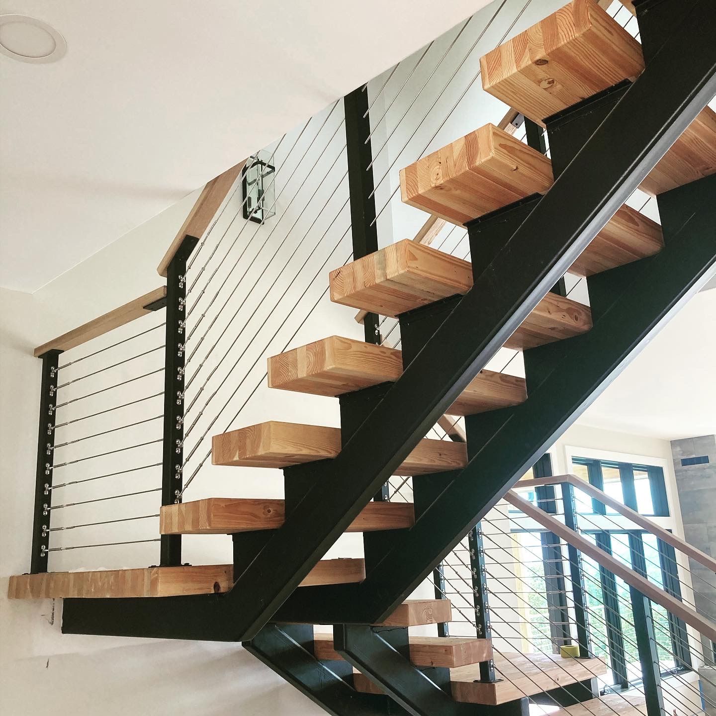 A staircase with wooden steps and a metal railing