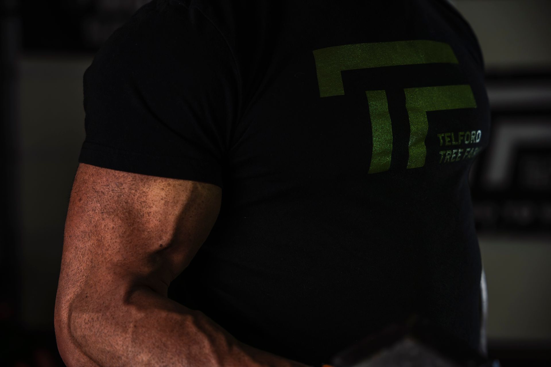 A close up of a man 's arm in a black shirt.