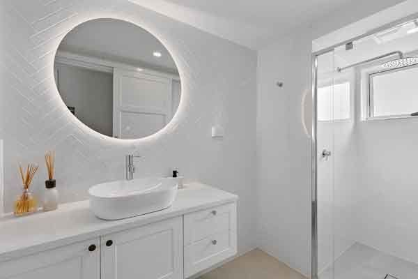 bathroom with circle mirror