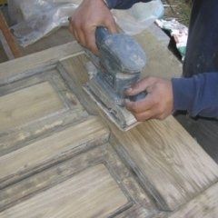 smerigliatura di un portone in legno