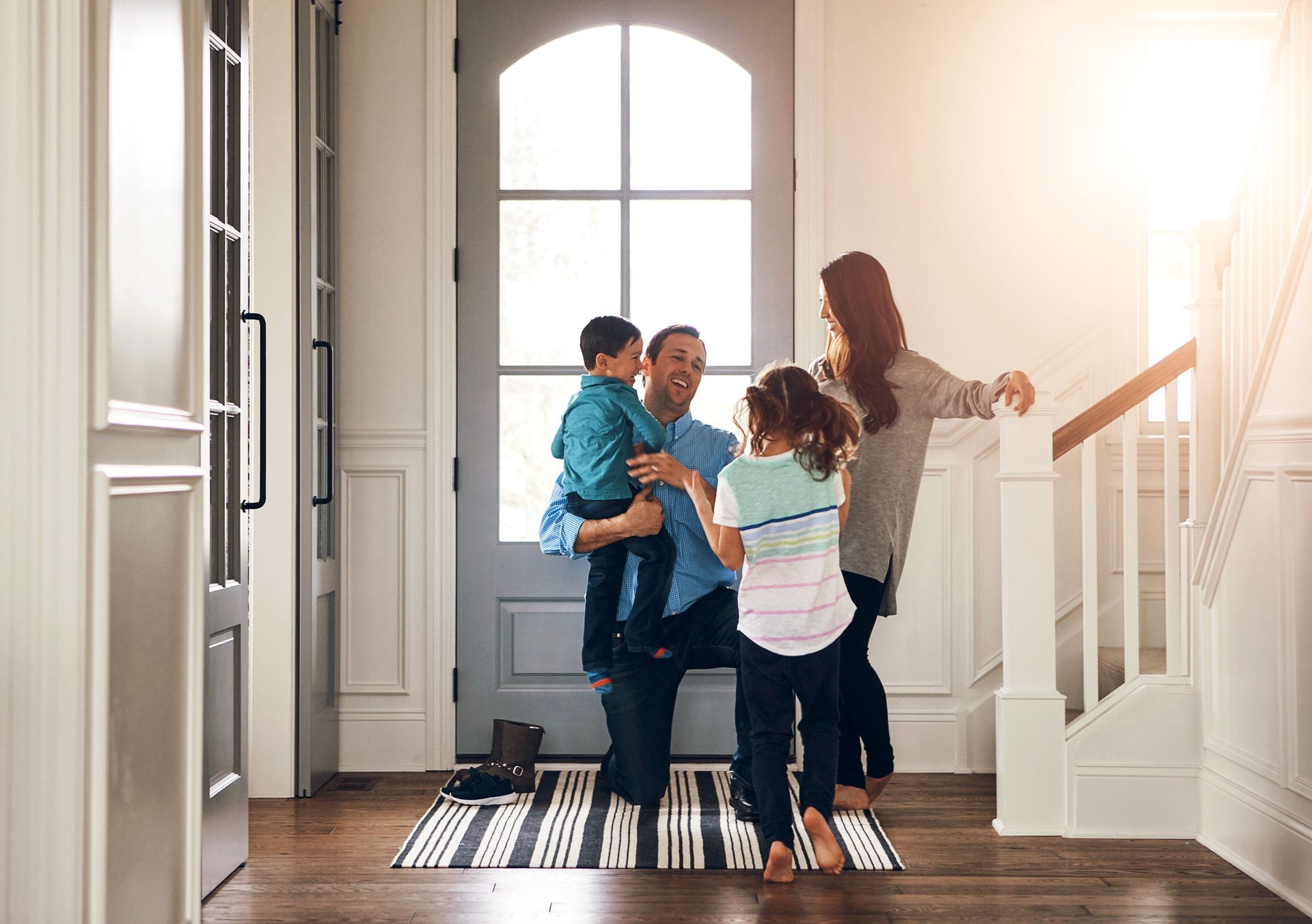 family walking into hardwood floor house