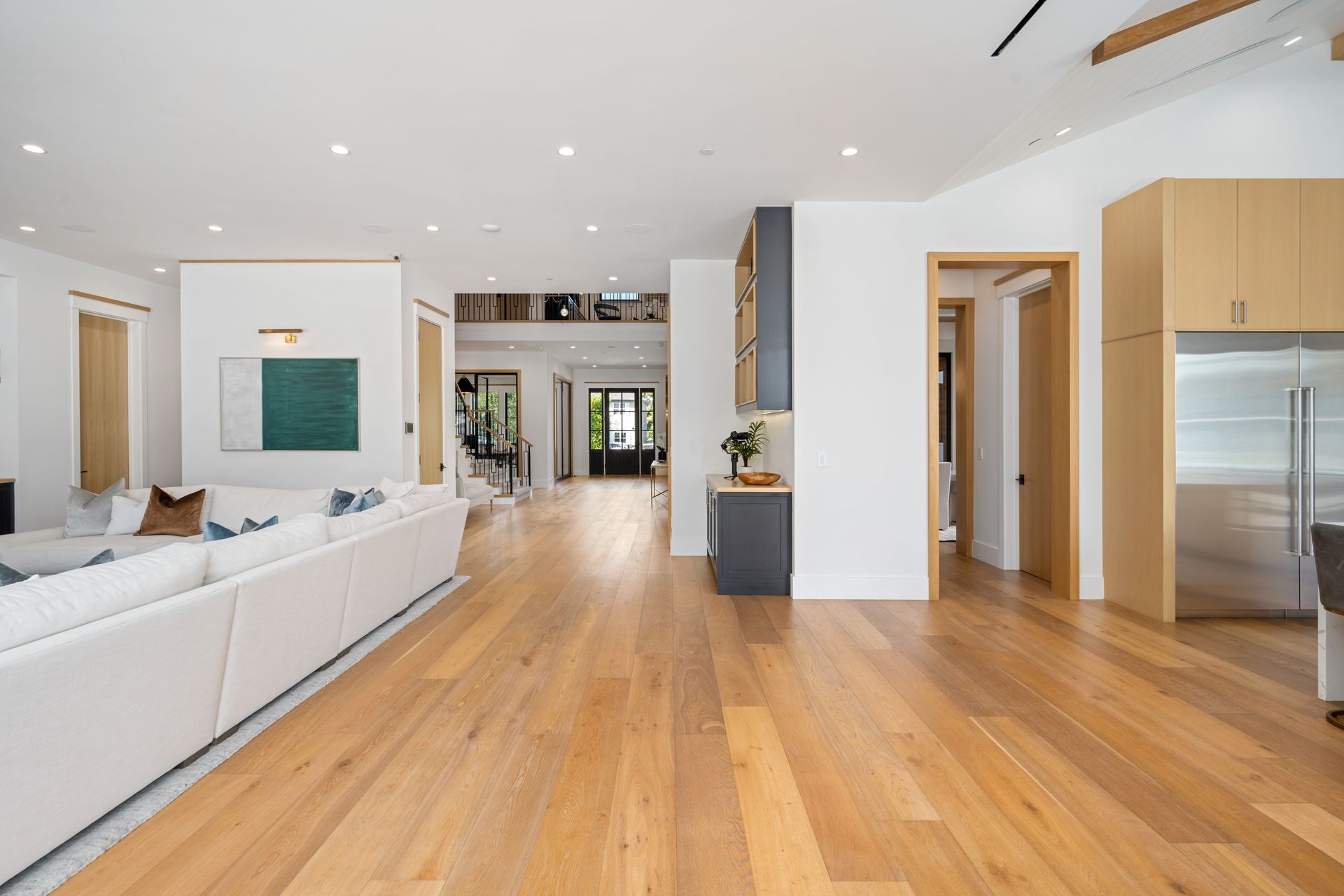 A living room with hardwood floors and a white couch.