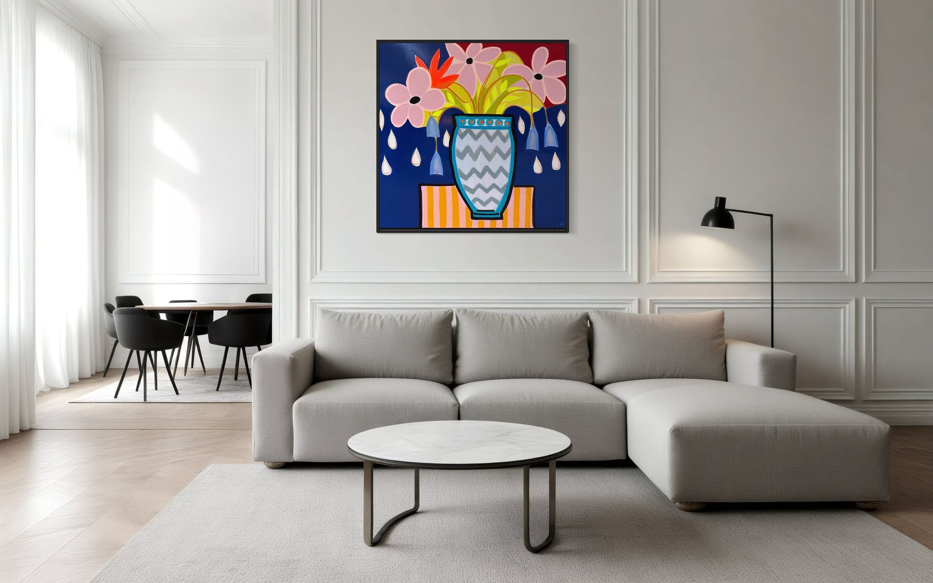 A living room with a couch , coffee table and a painting on the wall.