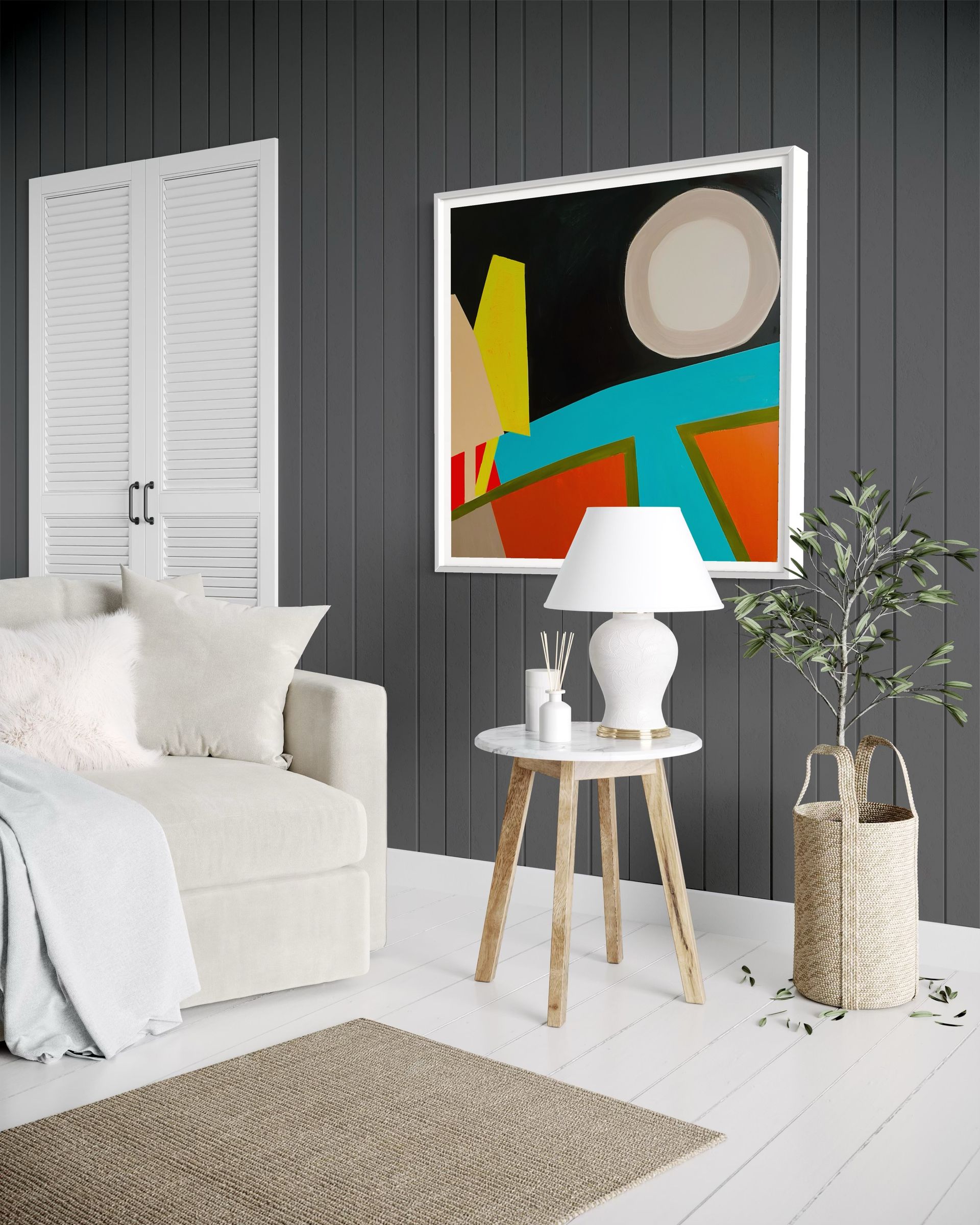 A living room with a couch , table , lamp and painting on the wall.