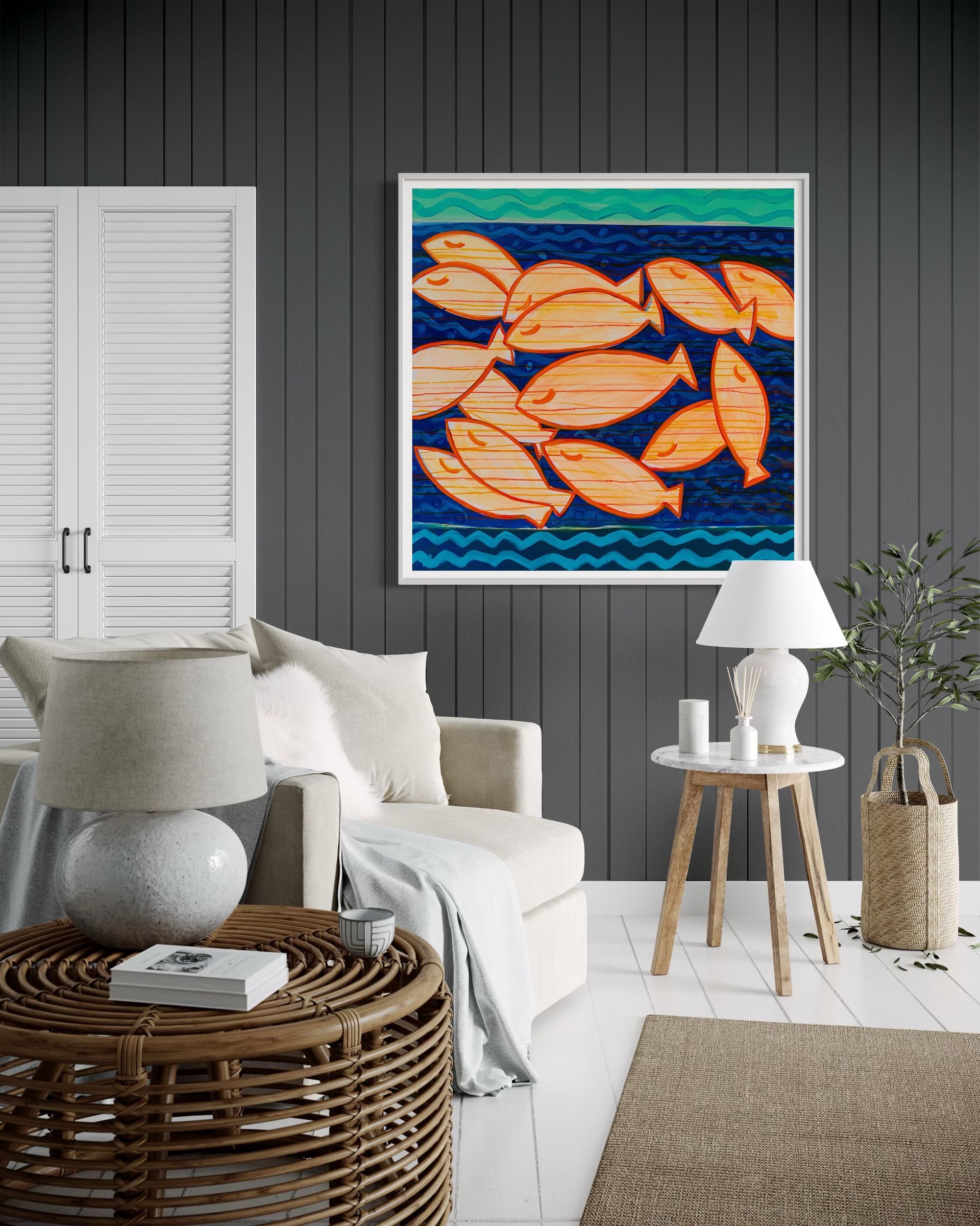 A living room with a couch , table , lamp and a painting of fish on the wall.