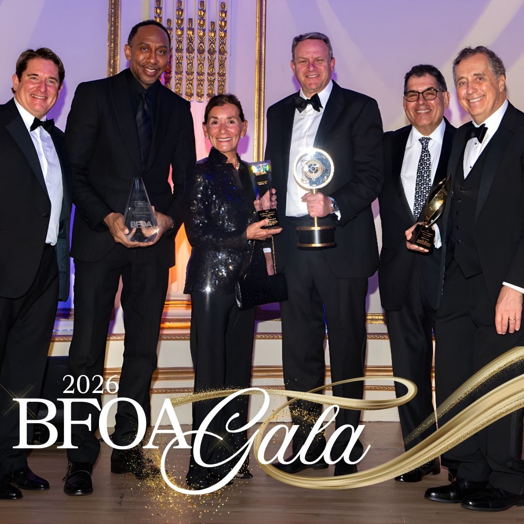 Six people posing with awards at the 2026 BFOA Gala, dressed in formal black attire