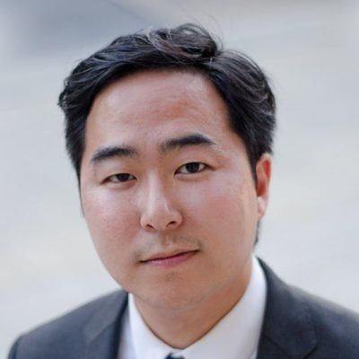 A man in a suit and tie is looking at the camera