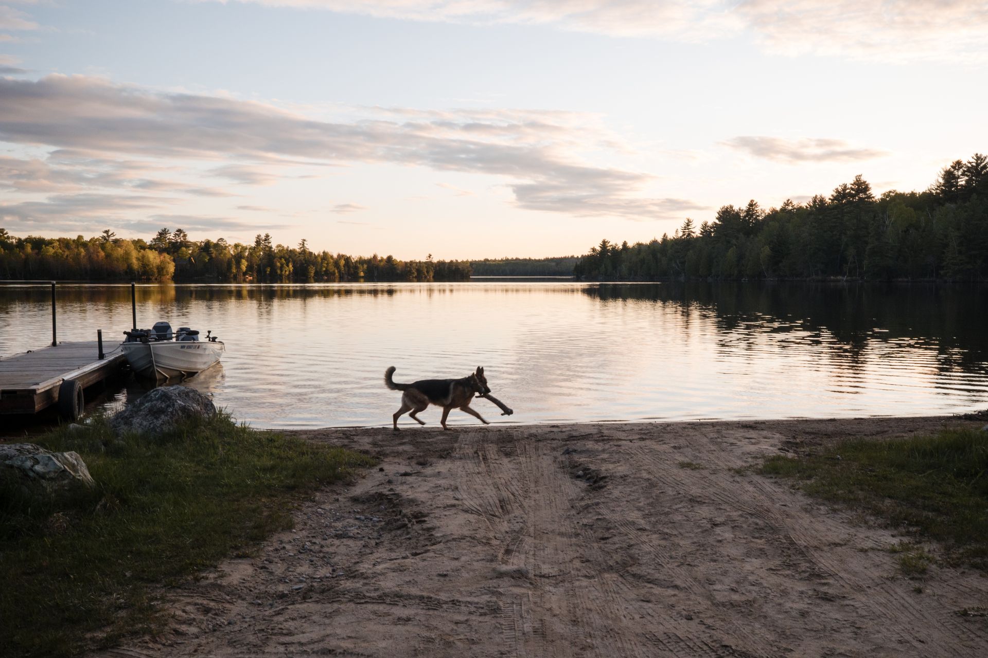 A picnic table with chairs in front of a lake