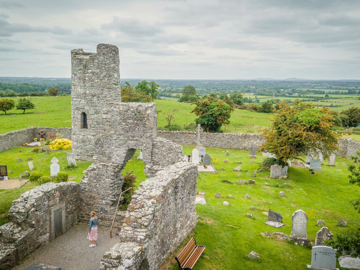 An aerial view of a cemetery with a castle in the background.