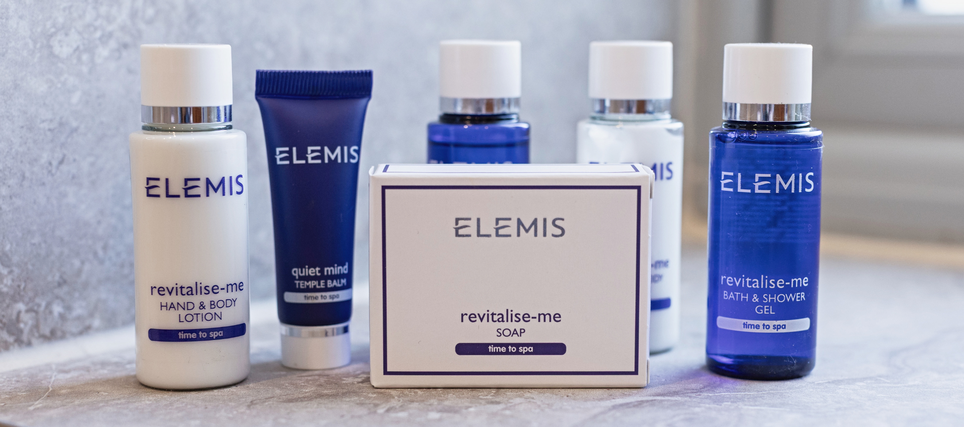 A variety of elemis cosmetics are sitting on a counter.