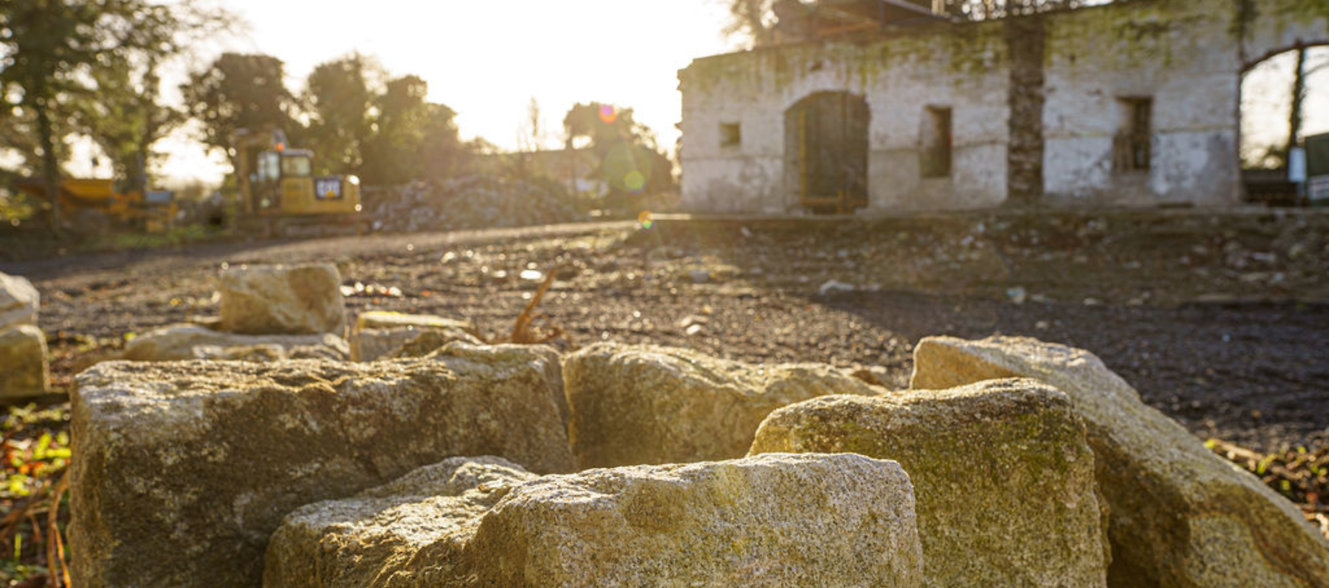 A pile of rocks is sitting in front of an old building.