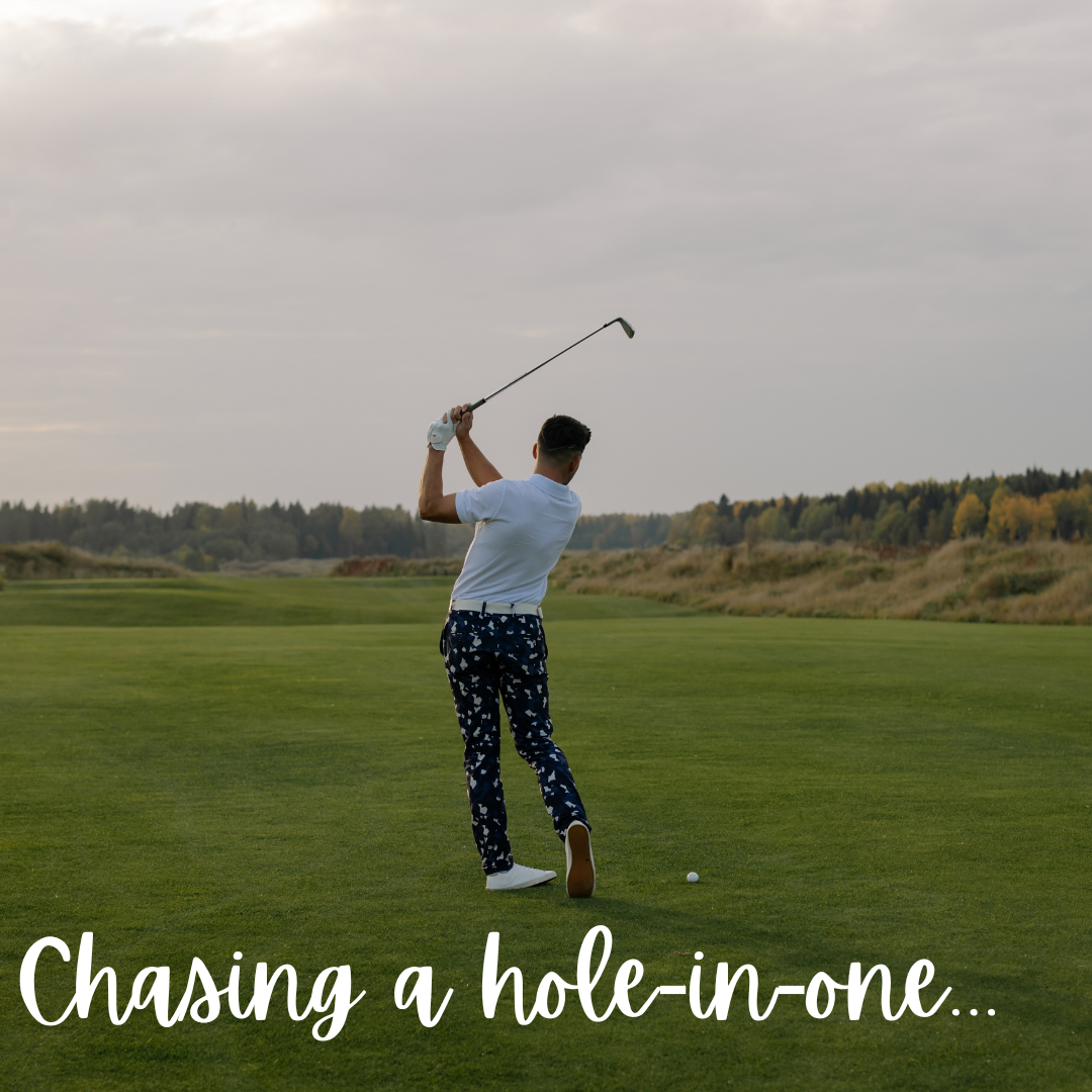 A man is chasing a hole in one on a golf course