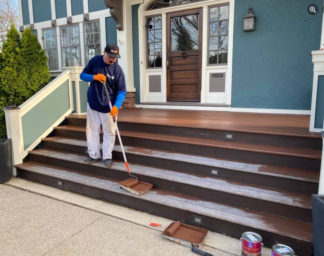 Man Painting The Stairs — Chicago, IL — Zion Construction Group