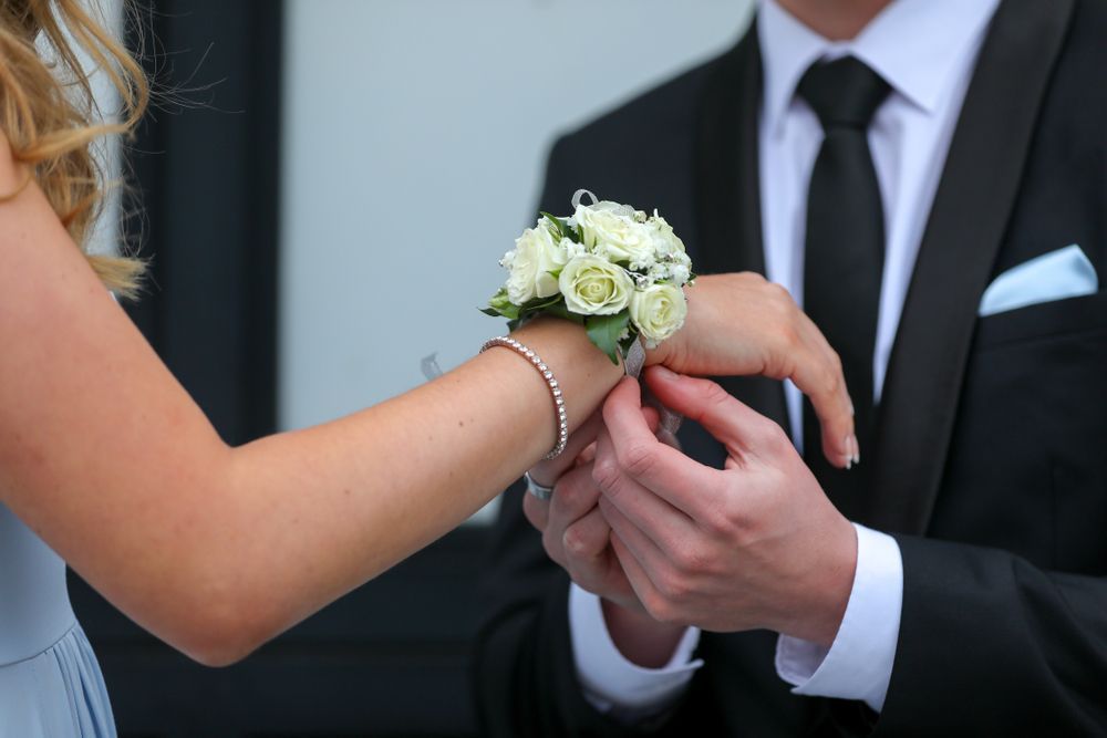 Man in Tuxedo Fastens a White Flower Corsage on A Woman's Wrist — Lakeview Luxury Retreat in Canobolas, NSW