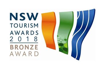 The logo for the nsw tourism awards 2018 bronze award