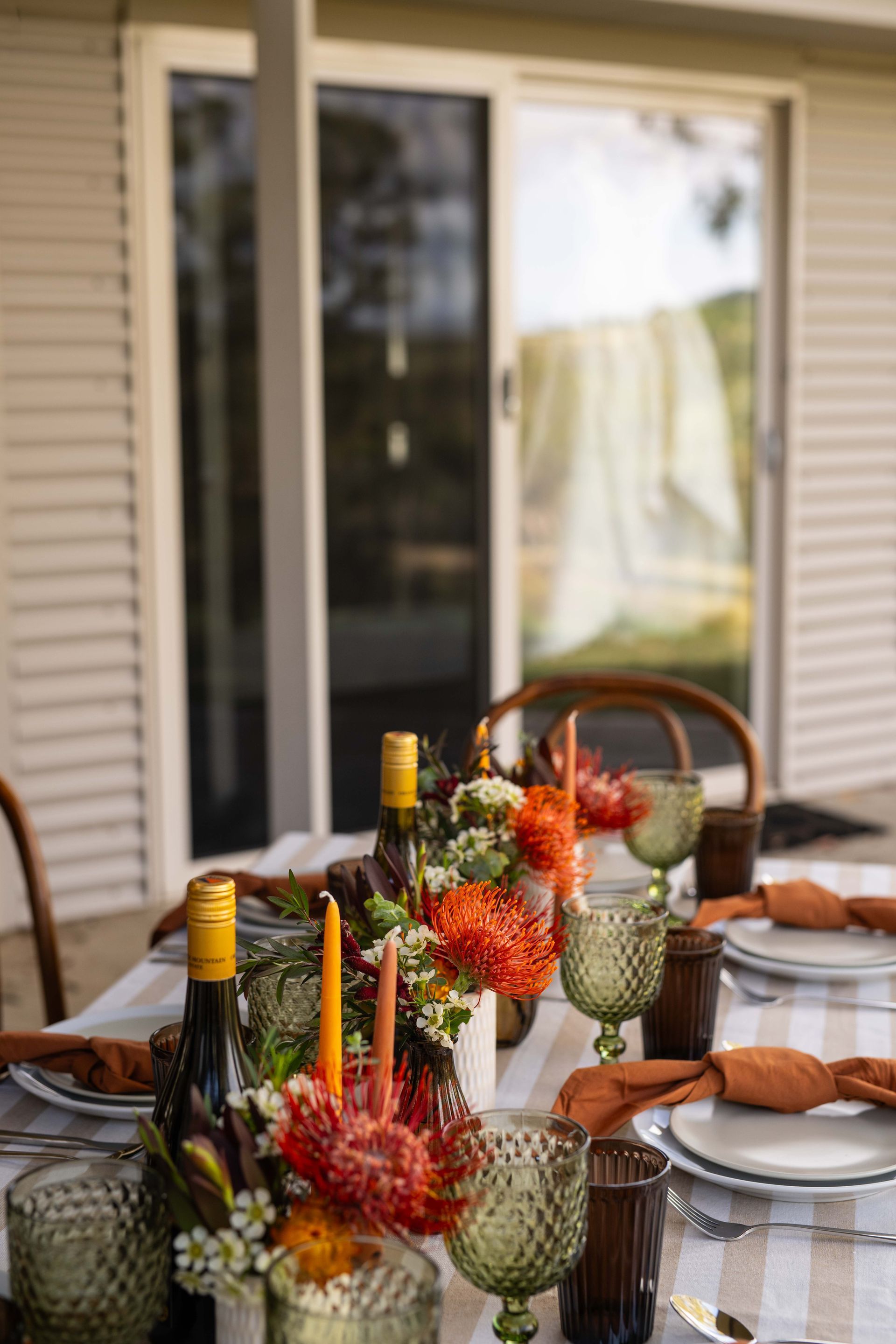 Outdoor Table Setting with Wine, Flowers, and Place Settings; Green and Brown Tones Against a Scenic View — Lakeview Luxury Retreat in Canobolas, NSW