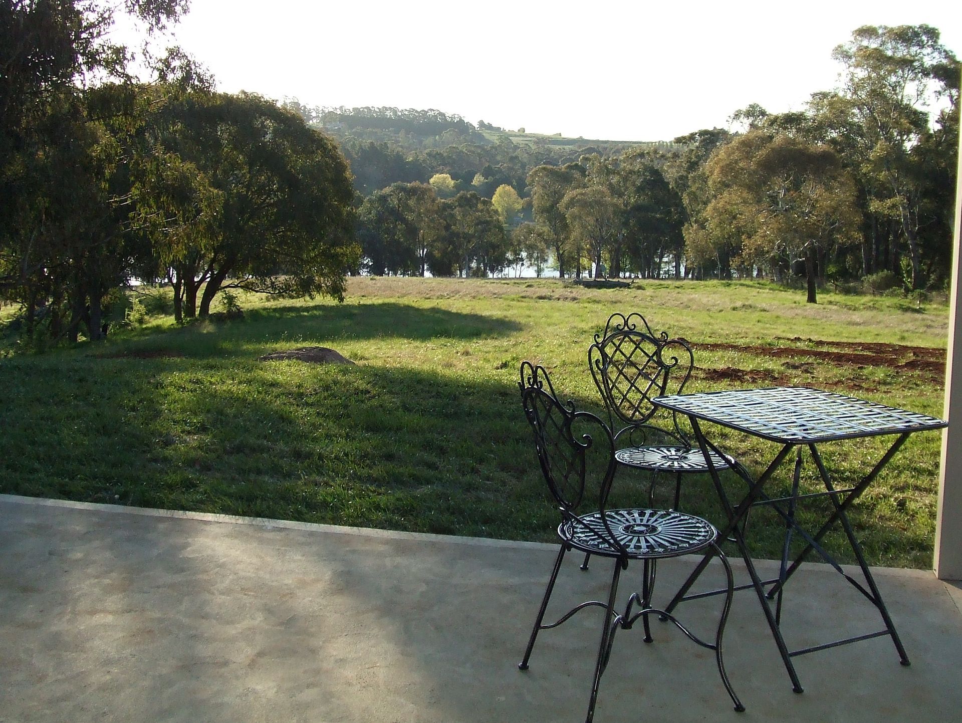 A Living Room With a Couch, Ottoman, and Table — Lakeview Luxury Retreat in Canobolas, NSW